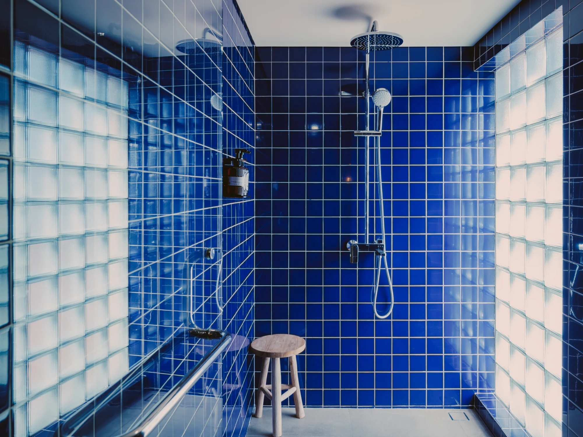 Spacious stone bathroom with hot shower and toiletries vanity