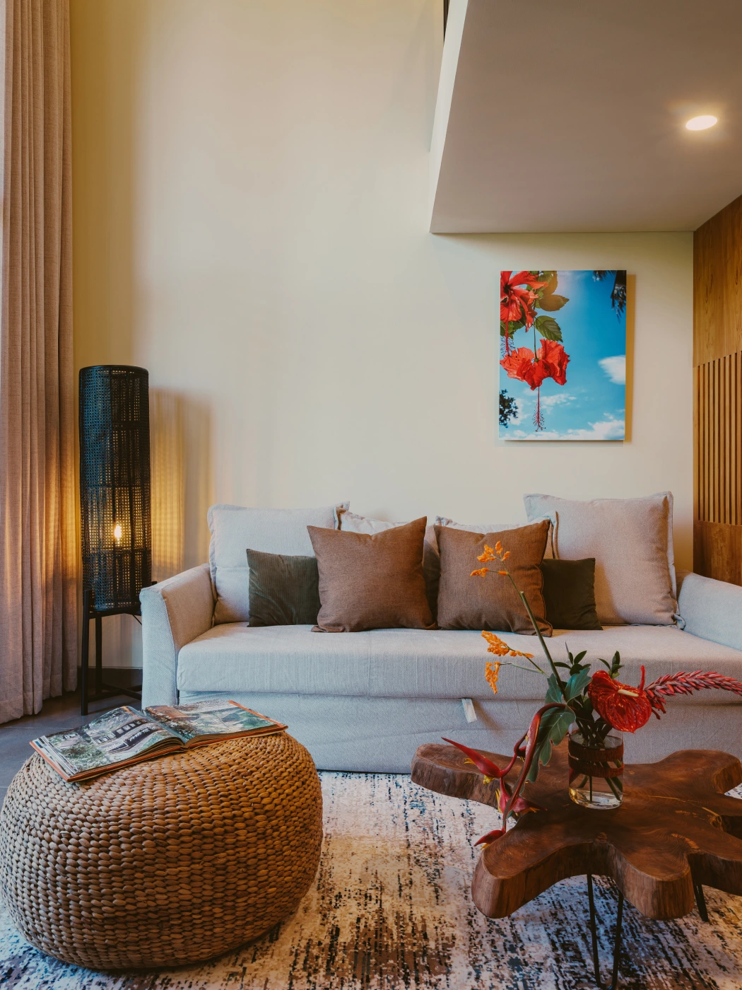 Deluxe Studio Apartment Mezzanine cosy living lounge with sofa, wooden coffee table, and woven ottoman