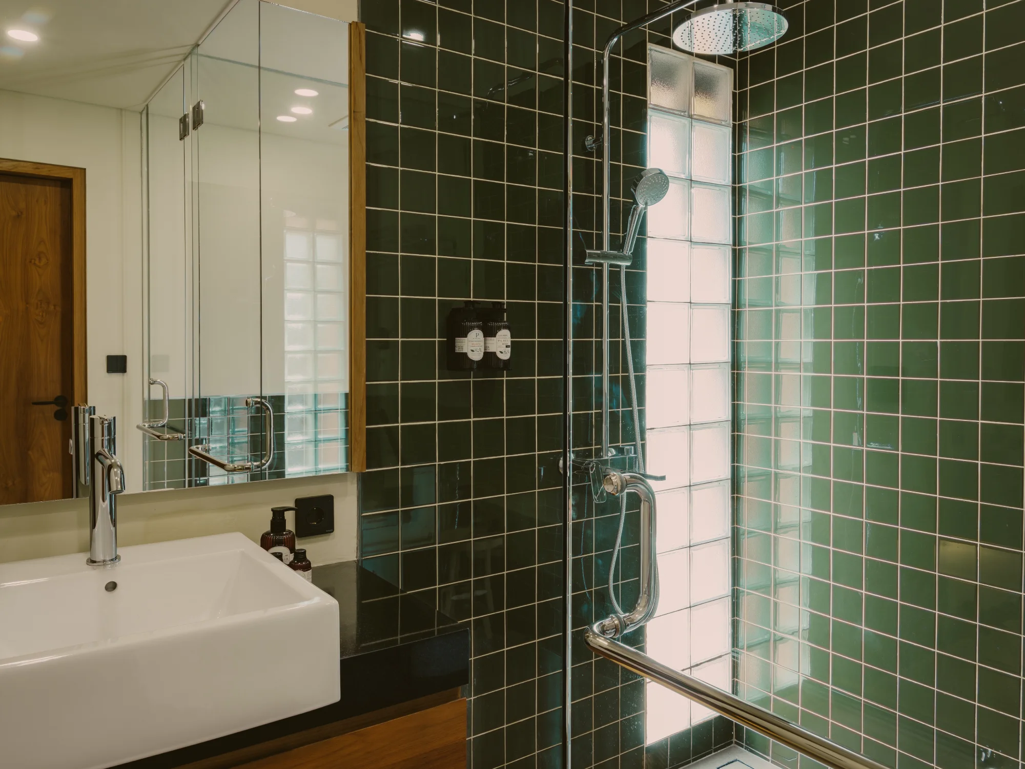 Contemporary stone bathroom with glass-enclosed shower
